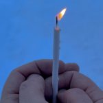 An image of a pair of hands holding a candle.