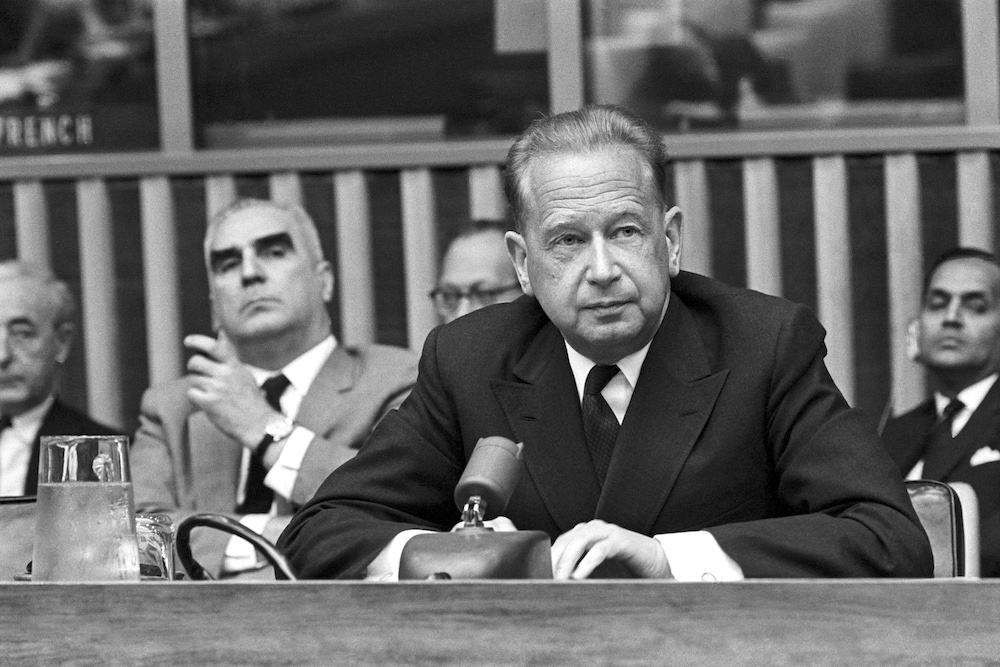 A photograph of UN Secretary-General Dag Hammarskjöld at a press conference